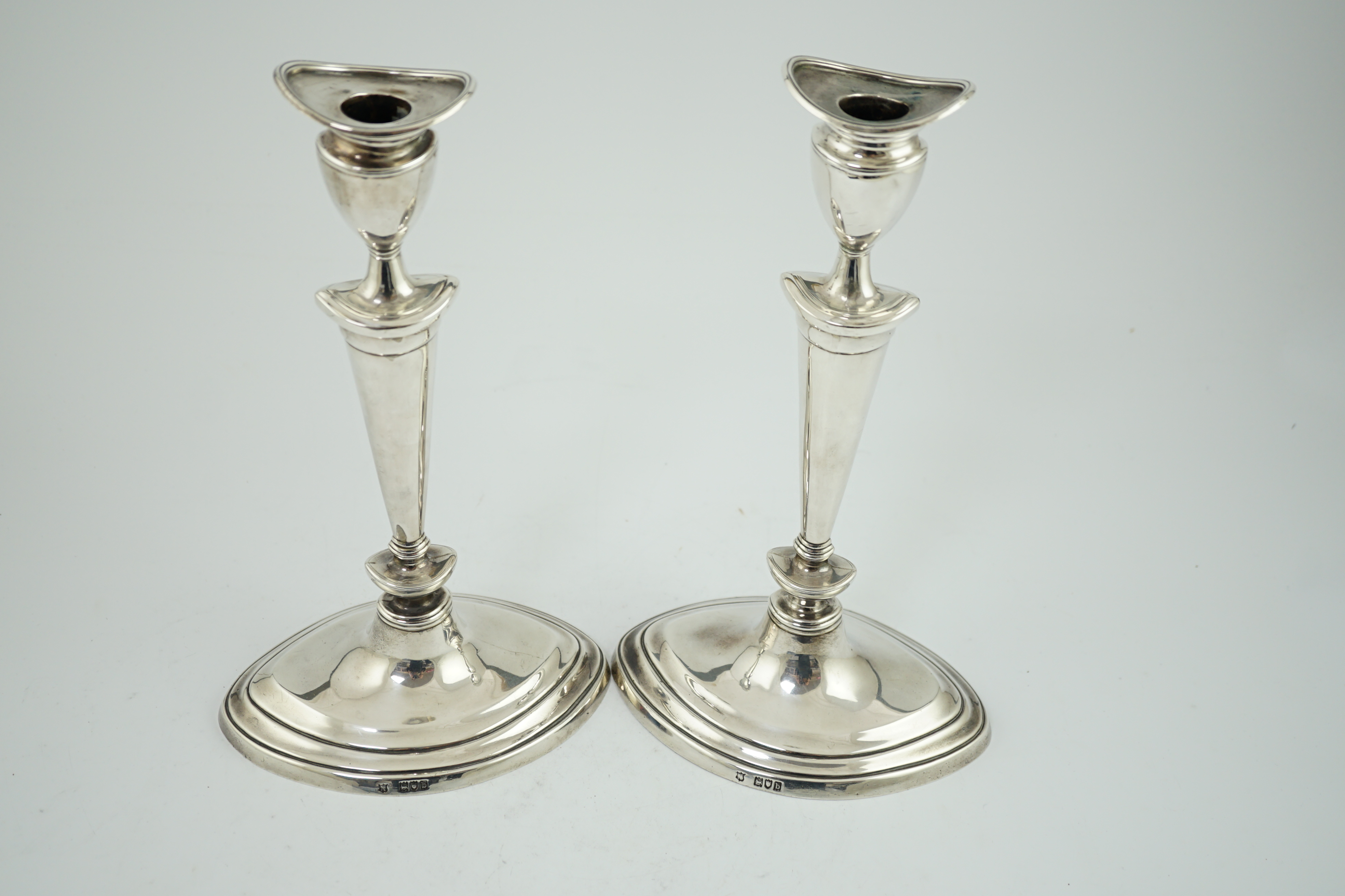 A pair of late Victorian silver oval candlesticks by Goldsmiths & Silversmiths (Gibson & Langman)